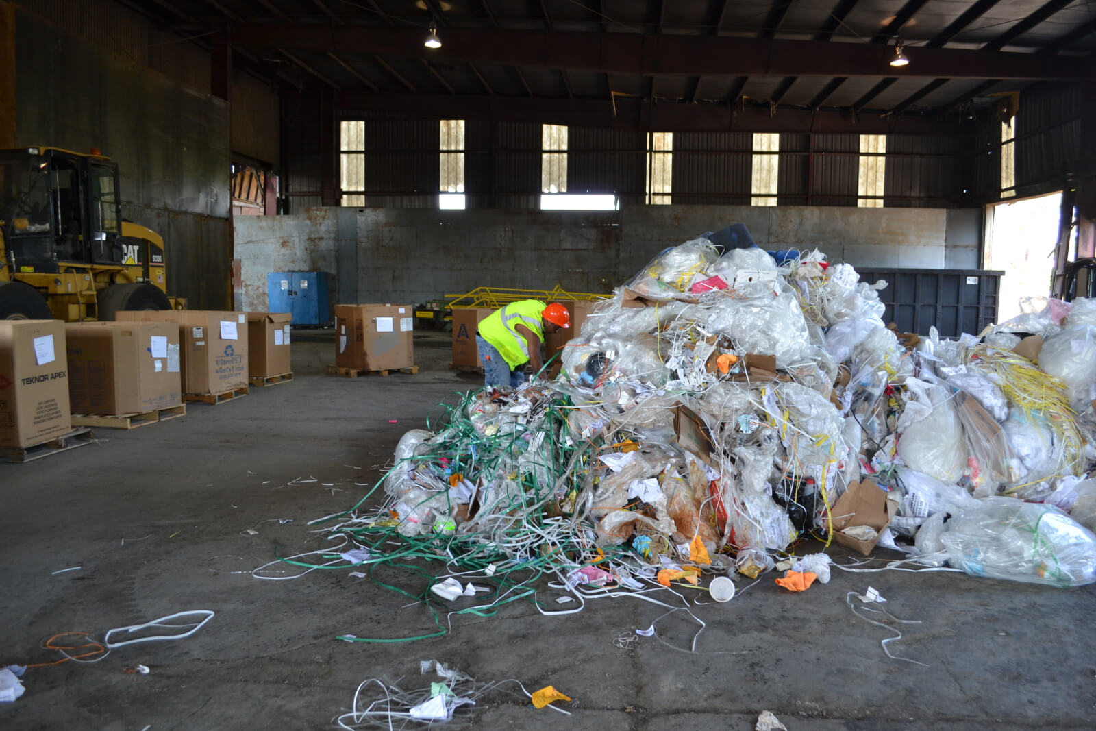 Rumpke Employee Looking Through Business Waste For An Audit