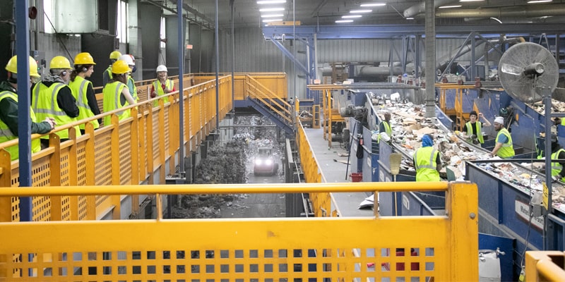 Rumpke Tour Guide Teaching A Group Inside Rumpke Recycling Facility