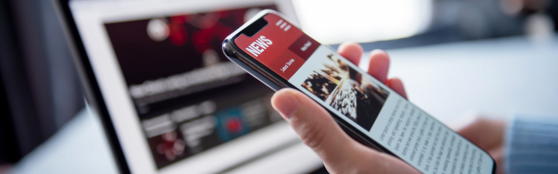 Hand Holding A Smartphone Displaying News And Media